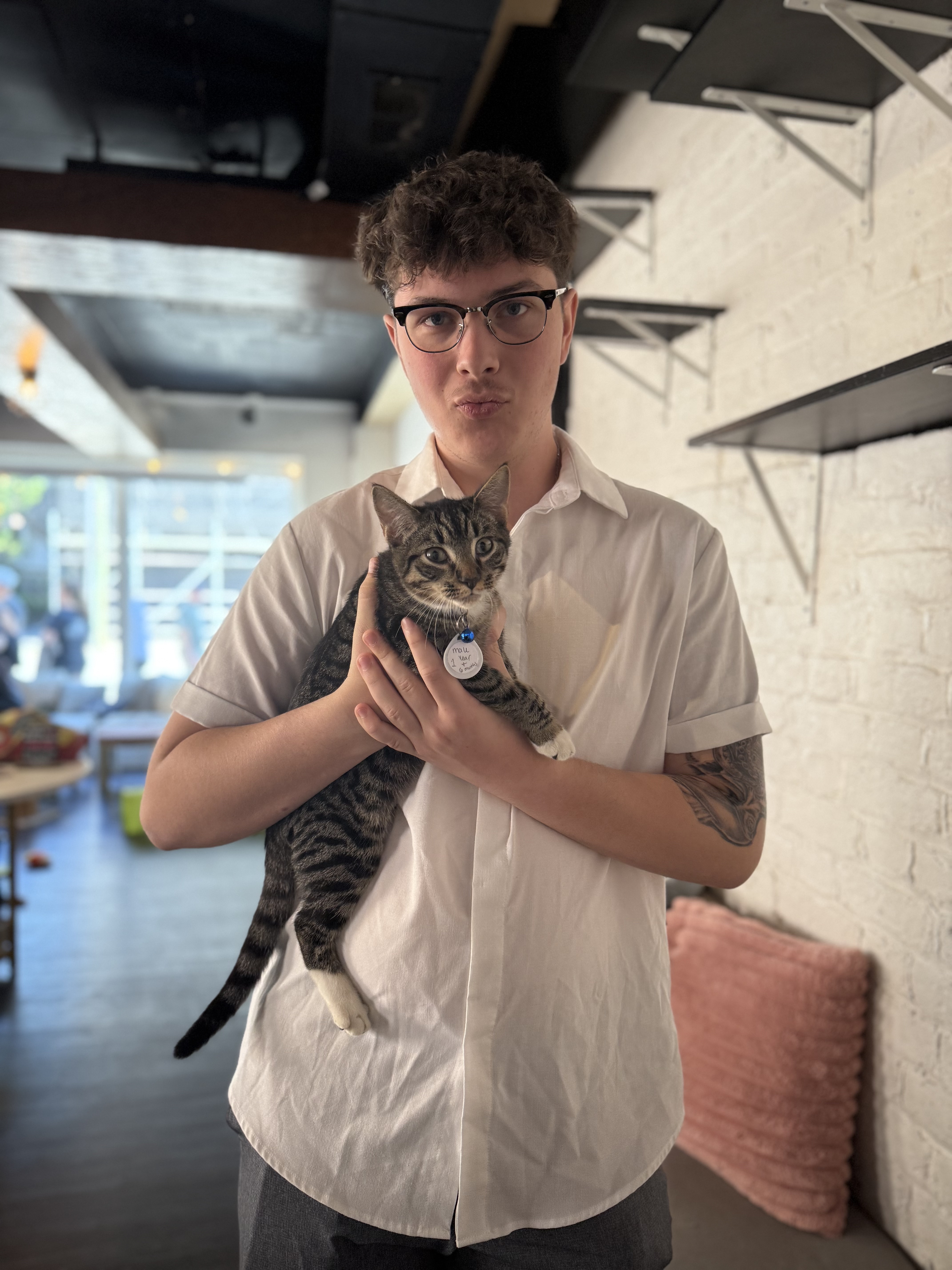 A picture of Gavin holding a cat.